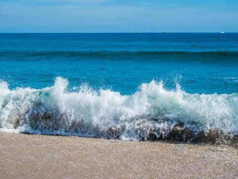 Ocean surf on the sandy beach Stock Photos