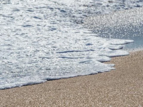 Ocean surf on the sandy beach Stock Photos
