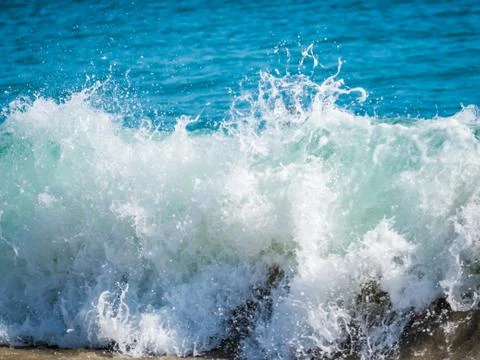 Ocean surf on the sandy beach Stock Photos