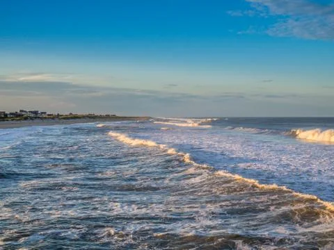 Ocean surf at sandy beach Stock Photos