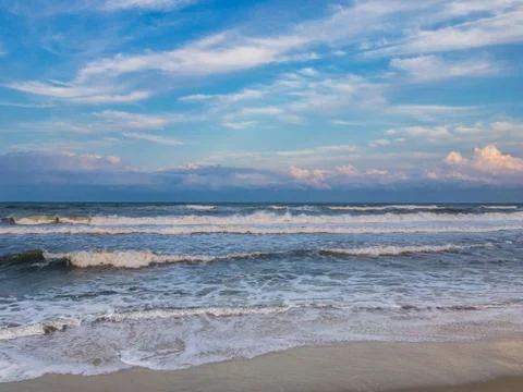 Ocean surf at sandy beach Stock Photos
