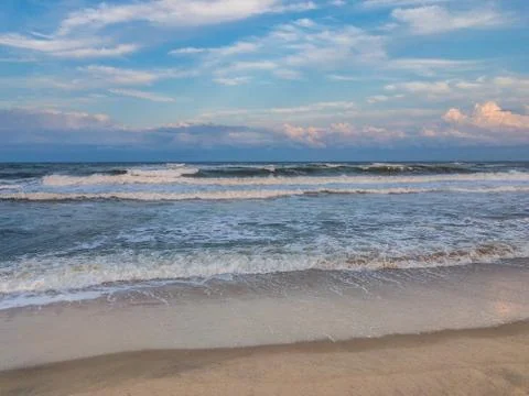 Ocean surf at sandy beach Stock Photos
