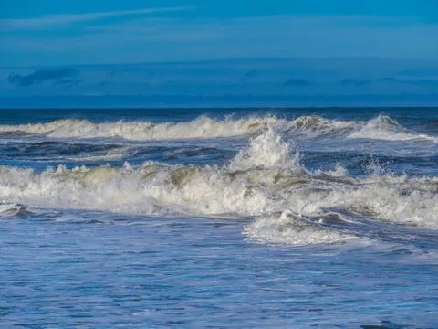 Ocean surf at sandy beach Stock Photos