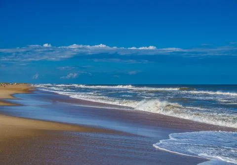 Ocean surf at sandy beach Stock Photos