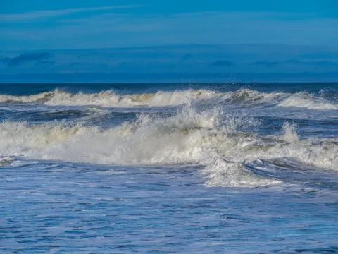 Ocean surf at sandy beach Stock Photos
