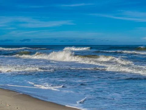 Ocean surf at sandy beach Stock Photos