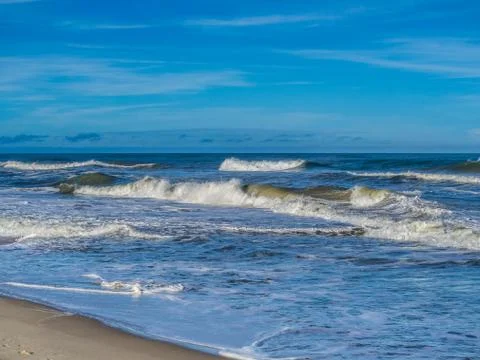 Ocean surf at sandy beach Stock Photos