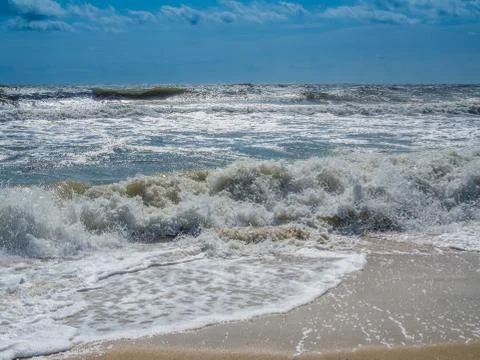 Ocean surf at sandy beach Stock Photos