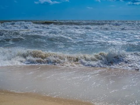Ocean surf at sandy beach Stock Photos