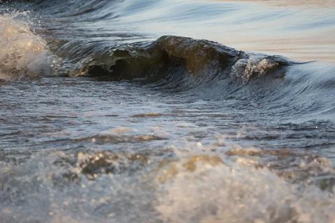 Ocean surf with warm evening light Photos