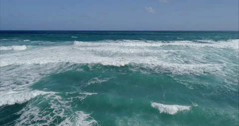 Ocean surf, waves and white sea foam against a light blue sky. Seascape of foamy Stock Footage 225449001