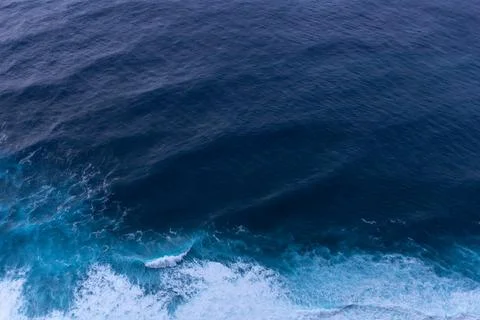 Ocean surf waves at sunset view from above Stock Photos