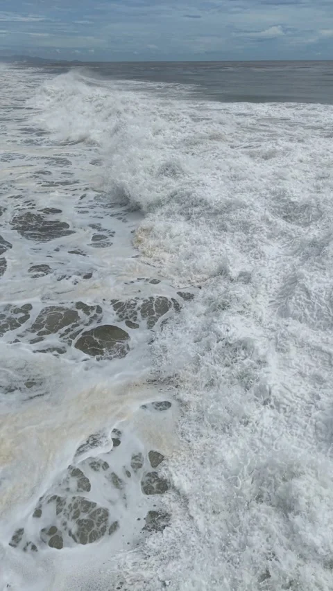 Ocean surface covered in storm foam, vertical drone, Pacific Mexico Stock Footage 348300768