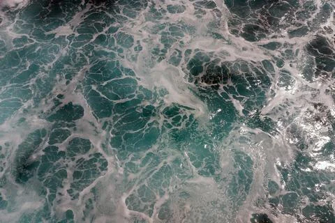 Ocean surface foaming from waves, texture and shape of sea water, aerial view Stock Photos