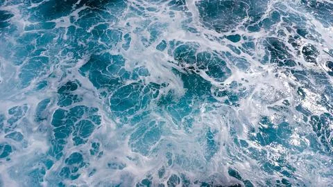 Ocean surface foaming from waves, texture and shape of sea water, aerial view 写真素材