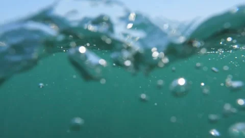 Ocean surface shot: camera plunges underwater, simulating a drowning experi.. Stock Footage 252732163