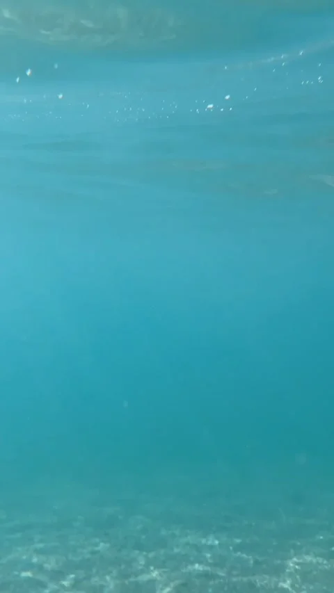 Ocean surface shot: camera plunges underwater, simulating a drowning experience. Stock Footage 332710140