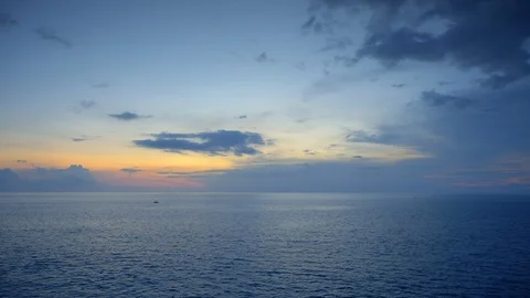 Ocean surface with small boat silhouette and beautiful dramatic sky Video stock 113553675