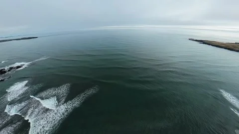 Ocean swell lines with distant headlands and gentle foam texture Stock Footage 341607334
