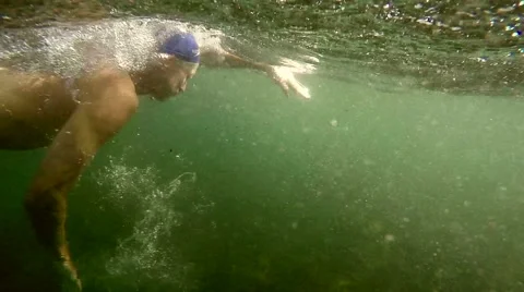 Ocean swimmer powers through the ocean off a Sydney beach. 120 fps. Video stock 63238226