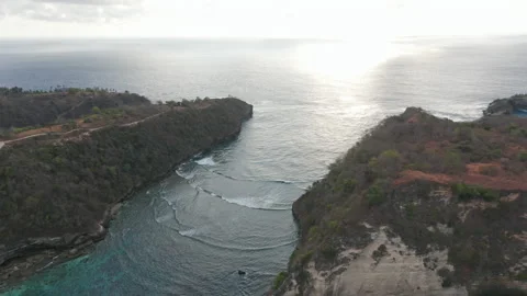 Ocean with Tiny Waves Forming in Between the Island Cliffs Stock Footage 133824917