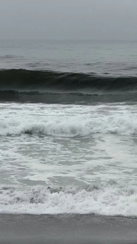 Ocean view with dark gray waves in cloudy weather in slow motion vertical video Stock Footage 306298286