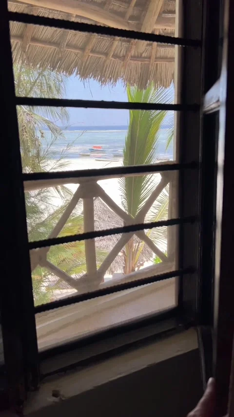 Ocean view from hotel room window thatched bungalow Zanzibar beach HD vertical Stock Footage 342148198