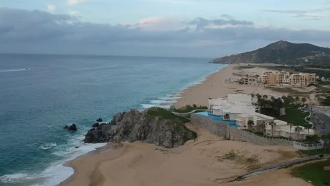 Ocean view mansion waves crashing in during sunrise Stock Footage 248477307