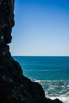 Ocean view through rocky cliffs Stock Photos