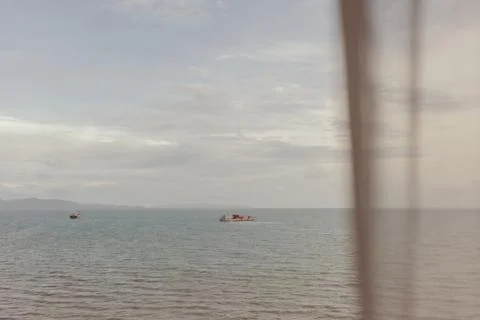 Ocean view through thin white curtain in summer. Stock-Fotos