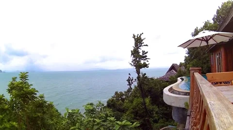 Ocean view villa with pool surrounded by tropical trees Stock Footage 55707988