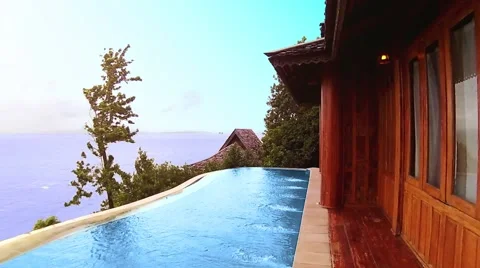 Ocean view villa with pool surrounded by tropical trees Video stock 55708973
