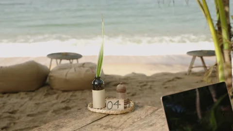 Ocean view with waves running, green palm trees and boho style cafe tables and Stock Footage 239522031