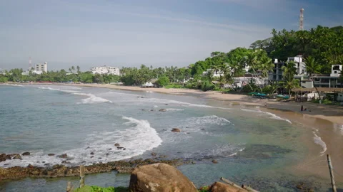 Ocean view with waves running, rocks and green island in the background. Sea Video stock 234095539
