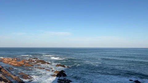 Ocean views with rolling waves smashing against the boulders Stock Footage 264012162