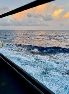 Ocean Wake Along Cargo Ship Side During Voyage At Sunset Stock Photos