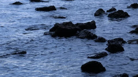 Ocean washes up on rocks Stock Footage 124852611