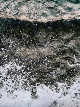 Ocean water creating natural pattern. Ocean water splashing with white foam Stock Photos