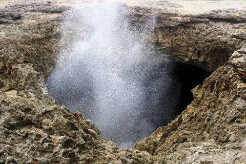 Ocean water exploding and crashing inside a cave Stock Photos