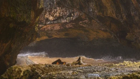 Ocean water lapping on the shore in a cave Stock Footage 116570460