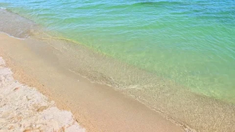 Ocean water meets sandy shore with soft wave motion Stock Footage 341741584