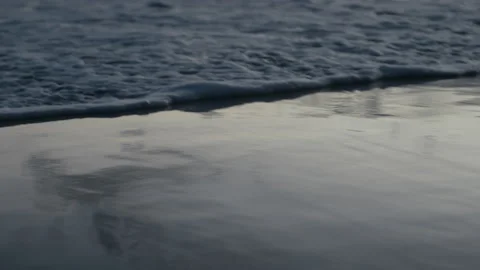 Ocean water rolling in and draining on the sand Stock Footage 169332032