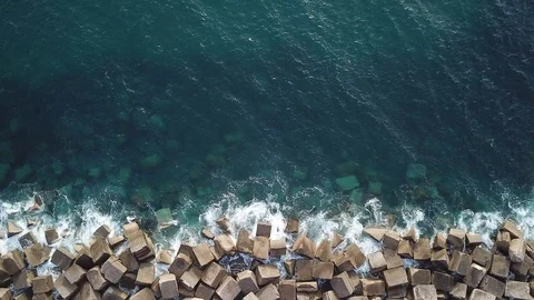 Ocean water surface texture view from above, cube stones on coastline Stock Footage 106413480