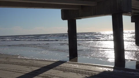 Ocean Water Waves Underneath Pier At Sunset Stock Footage 127780351