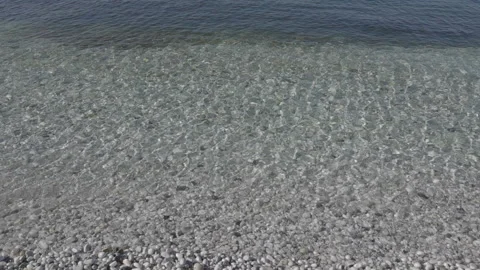 Ocean water waves on white pebbles beach slow motion c-log footage (02) Stock Footage 220129030