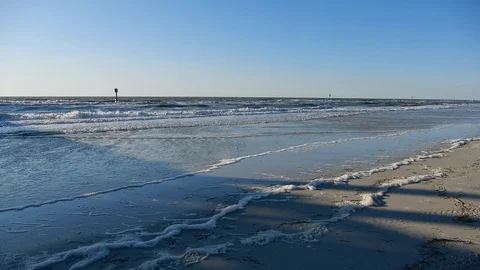 Ocean Water On White Sandy Beach With Signs In Distance Stock Footage 127186567