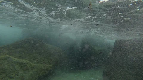 Ocean Wave action on rocks shot underwater Stock-Footage 337847389