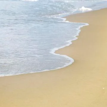 Ocean wave and beach Stock Photos