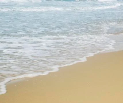 Ocean wave and beach Stock Photos