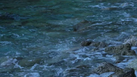 Ocean wave beats of the big rocks standing in the ocean. Close up of big Stock Footage 186775694
